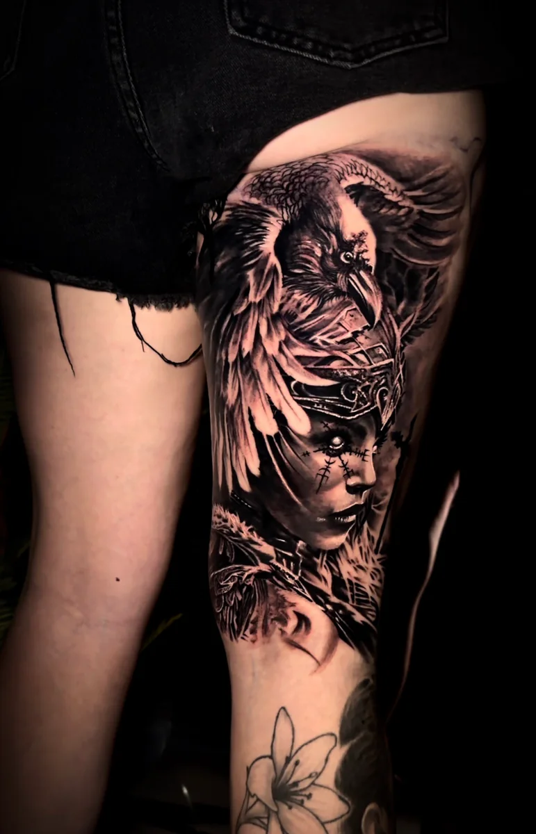 Raven and portrait thigh tattoo